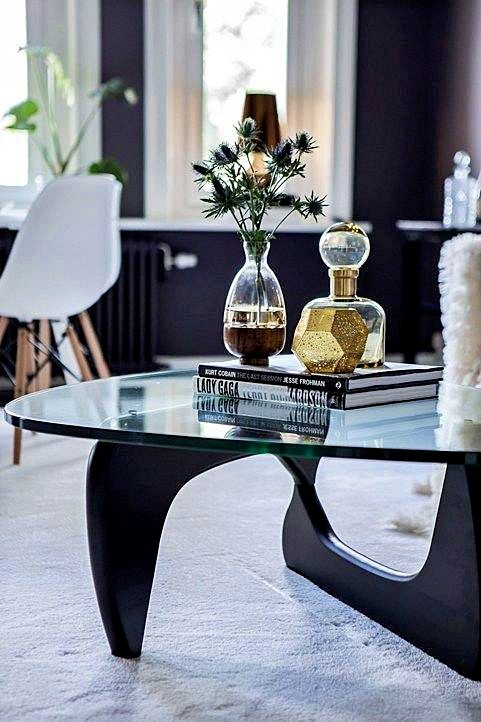 Innist sculptural coffee table in dark walnut, lifestyle setting with biomorphic wooden base and tempered glass top