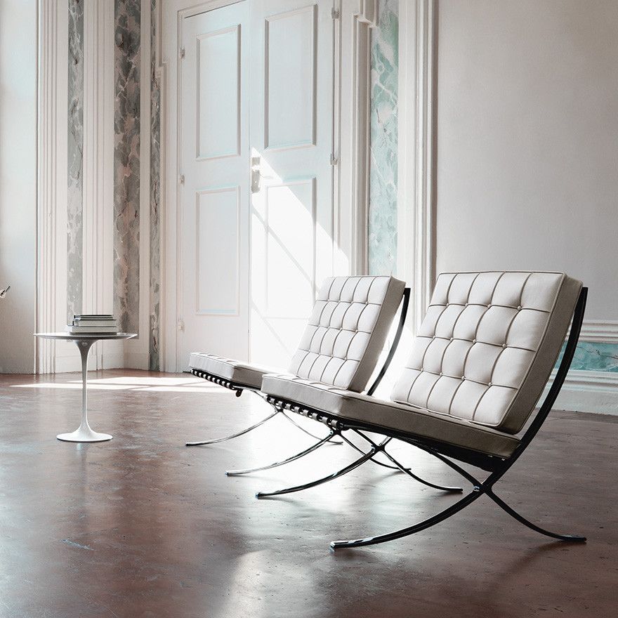 Two Pavilion lounge chairs in white tufted full-grain leather, lifestyle living room setting with polished steel frames