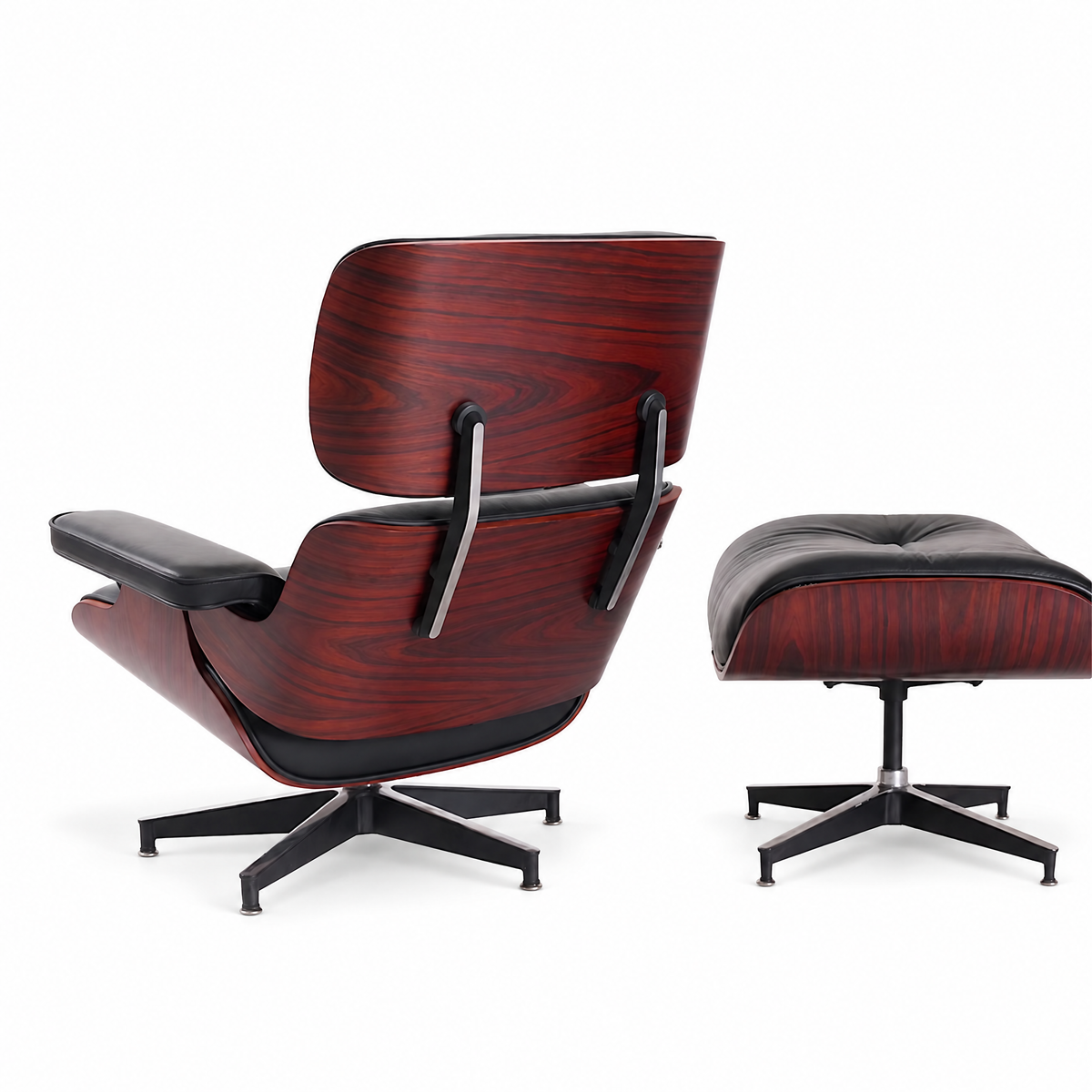 Mid-century lounge chair and ottoman in black full-grain leather with rosewood veneer, rear three-quarter view