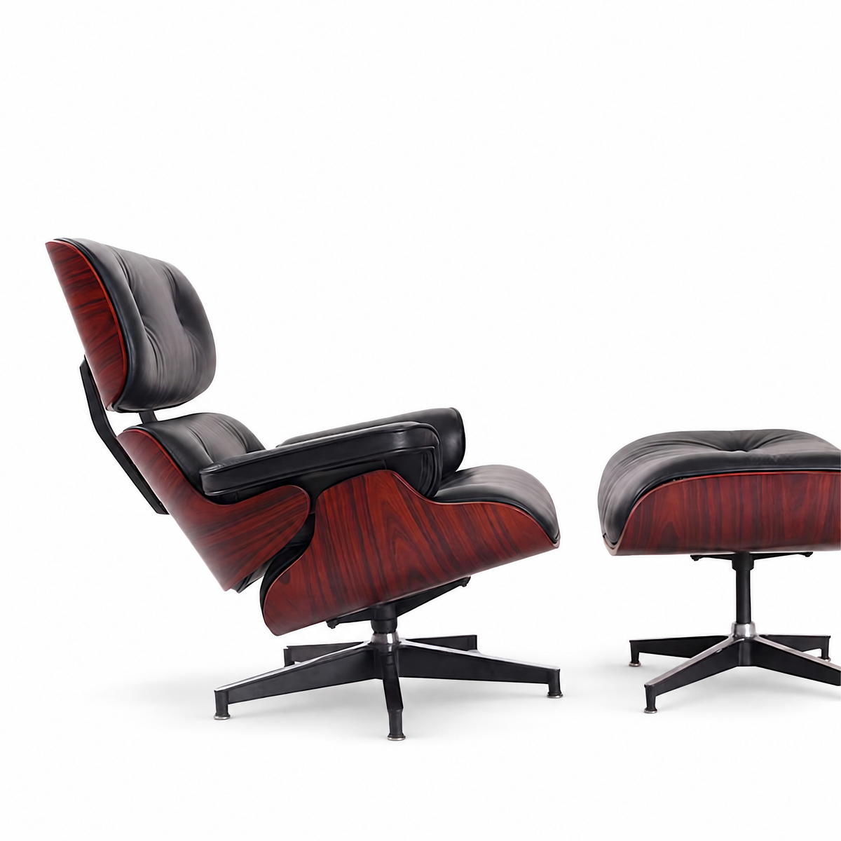 Mid-century lounge chair and ottoman in black full-grain leather with rosewood veneer, side view
