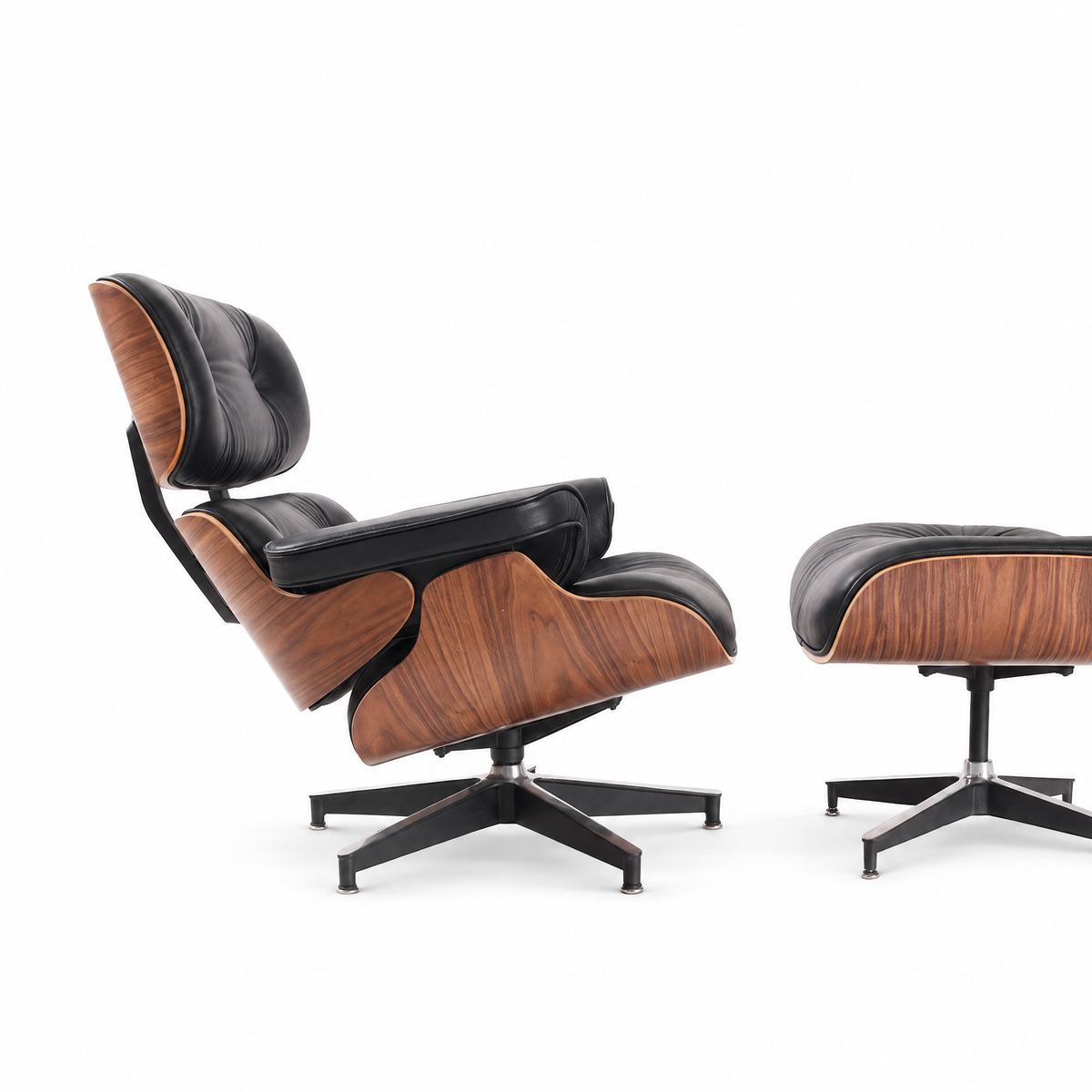 Mid-century lounge chair and ottoman in black full-grain leather with walnut veneer, side view