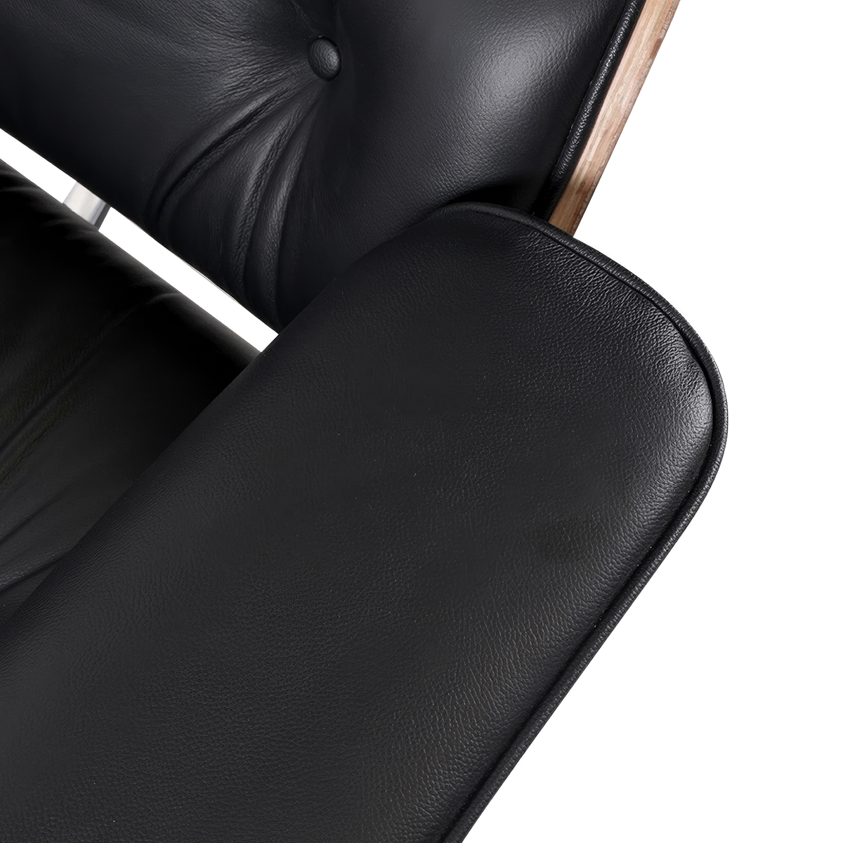 Armrest close-up of a mid-century lounge chair in black leather with walnut veneer