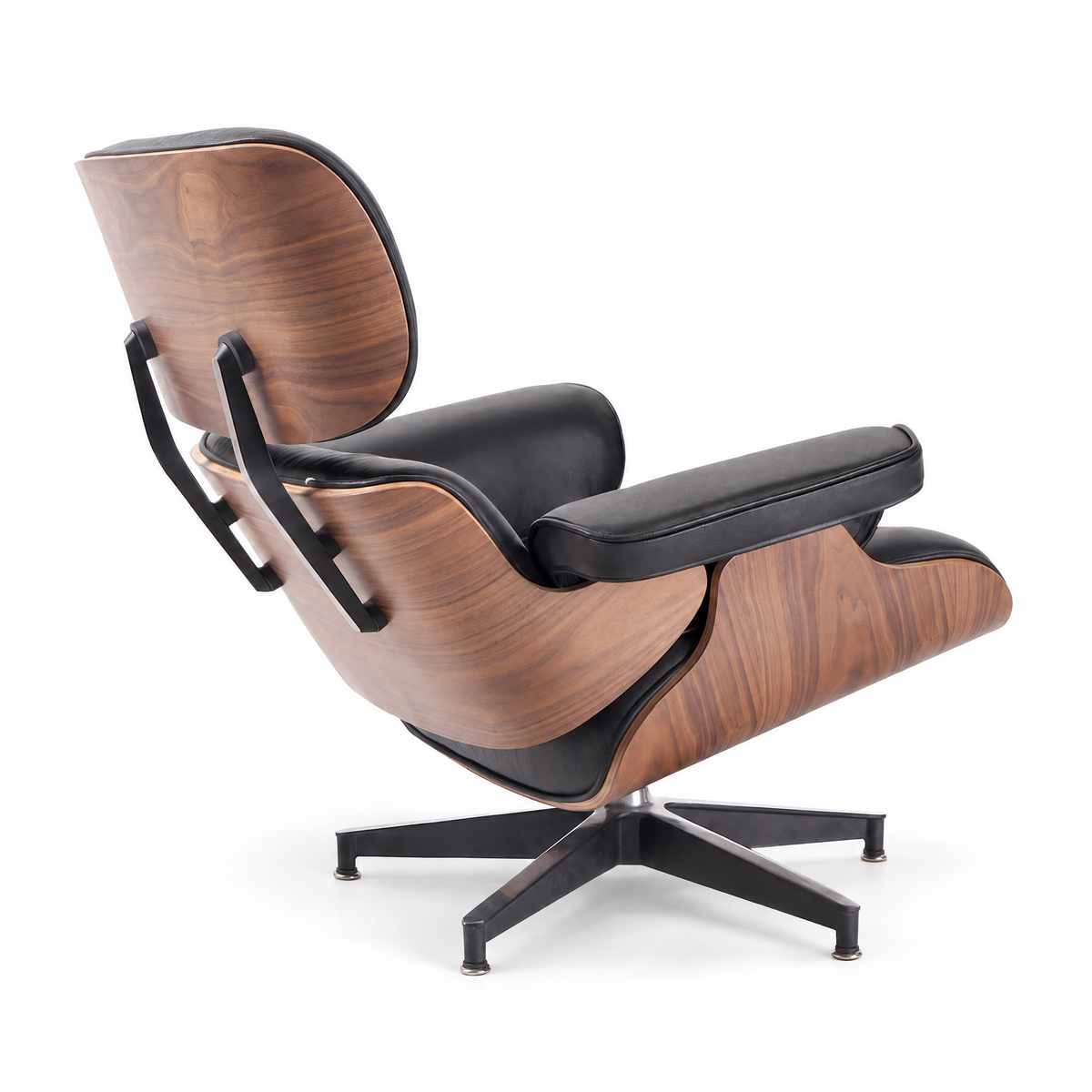 Mid-century lounge chair in black leather with walnut veneer, rear three-quarter view